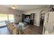 Inviting living room showcasing hardwood floors, pool access, and chic furniture at 25631 Bruford Blvd, Land O Lakes, FL 34639