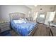 Cozy main bedroom with grey walls, wood floors, and a vanity near a full bathroom at 25631 Bruford Blvd, Land O Lakes, FL 34639