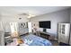 Bright bedroom featuring a ceiling fan, TV, dresser, and a seating area at 25631 Bruford Blvd, Land O Lakes, FL 34639