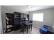 Well-lit home office with dark wood desk and chairs and built-in shelving at 25631 Bruford Blvd, Land O Lakes, FL 34639