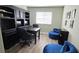 Bright office featuring built-in bookshelves, desk, and cozy blue seating at 25631 Bruford Blvd, Land O Lakes, FL 34639
