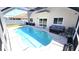 Backyard pool area with patio seating and screened enclosure at 25631 Bruford Blvd, Land O Lakes, FL 34639