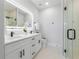 Modern bathroom with double vanity, LED mirror, and glass-enclosed shower at 2608 W Saint Joseph St # 2, Tampa, FL 33607