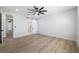 Bright, open bedroom featuring wood-look flooring, barn door to ensuite bathroom, and ample natural light at 2608 W Saint Joseph St # 2, Tampa, FL 33607