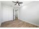 Bedroom showcasing wood-look floors, closet doors, and access to an en-suite bathroom for added convenience at 2608 W Saint Joseph St # 2, Tampa, FL 33607