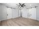Spacious bedroom boasts wood-look floors, sliding barn doors, and ample natural light at 2608 W Saint Joseph St # 2, Tampa, FL 33607