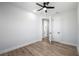 Spacious bedroom with wood-look flooring, a modern ceiling fan, and a glimpse into the en-suite bathroom at 2608 W Saint Joseph St # 2, Tampa, FL 33607