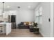 Living room with gray sofa, wood flooring, and view of the kitchen at 2608 W Saint Joseph St # 2, Tampa, FL 33607