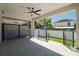 Covered patio with gray tile flooring, ceiling fan, and view of the fenced backyard at 2608 W Saint Joseph St # 2, Tampa, FL 33607