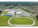 Aerial view of a community school with football field, track, and basketball courts at 2671 Murray Pass, Odessa, FL 33556
