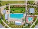 Aerial view of the community pool and splash pad, surrounded by lush landscaping and walking paths at 2671 Murray Pass, Odessa, FL 33556