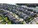 Expansive aerial shot of a residential community with tree-lined streets and a scenic lake at 2671 Murray Pass, Odessa, FL 33556