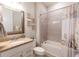 Bright bathroom featuring granite countertops, tiled shower, and seashell decor at 2671 Murray Pass, Odessa, FL 33556