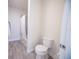Bathroom featuring a shower-tub combination with a white shower curtain and a standard toilet with a closed lid at 2671 Murray Pass, Odessa, FL 33556