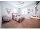 Cozy bedroom featuring neutral tones, natural light, and a comfortable armchair at 2671 Murray Pass, Odessa, FL 33556