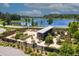 Aerial view of community garden overlooking lake with raised beds and tool shed at 2671 Murray Pass, Odessa, FL 33556
