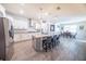 Well-lit kitchen boasts stainless steel appliances, a large island with seating, and an open flow to the dining area at 2671 Murray Pass, Odessa, FL 33556