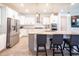 Modern kitchen featuring an island with seating, stainless steel appliances, pendant lighting, and white cabinets at 2671 Murray Pass, Odessa, FL 33556