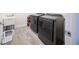 Laundry room featuring brand new, dark grey appliances and a utility sink with tiled floors for modern appeal at 2671 Murray Pass, Odessa, FL 33556