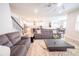 Comfortable living room open to the kitchen, featuring a plush sofa, stylish decor, and hardwood floors at 2671 Murray Pass, Odessa, FL 33556