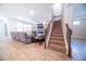 Inviting living room with stairs, plush sofa, modern fireplace, and large television for comfortable gatherings at 2671 Murray Pass, Odessa, FL 33556