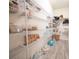 Organized walk-in pantry with wire shelving, clear containers, and neatly arranged food items, providing ample storage at 2671 Murray Pass, Odessa, FL 33556