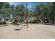 Playground with climbing structure and slide surrounded by mature trees and mulch at 2671 Murray Pass, Odessa, FL 33556