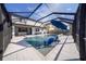 This screened-in pool features comfortable seating and a tranquil atmosphere for relaxation and enjoyment at 2671 Murray Pass, Odessa, FL 33556