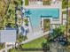 Overhead shot of community pool featuring lounge seating, palm trees and green space at 2671 Murray Pass, Odessa, FL 33556