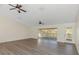 Spacious living room with modern floors, ceiling fans, and glass doors to the outdoor deck at 27026 Golden Meadow Dr, Wesley Chapel, FL 33544