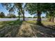 Beautifully maintained backyard with lush lawn and tall privacy fence, enhanced by mature trees at 2707 Morningside Dr, Clearwater, FL 33759