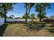 Large, shady backyard enclosed by a white privacy fence, perfect for outdoor activities at 2707 Morningside Dr, Clearwater, FL 33759