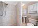Functional bathroom with tiled walls, a stand-up shower, and a pedestal sink at 2707 Morningside Dr, Clearwater, FL 33759