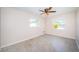 Bedroom with a ceiling fan and two windows providing plenty of natural light at 2707 Morningside Dr, Clearwater, FL 33759