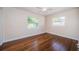 Empty bedroom with hardwood floors and natural light from two windows at 2707 Morningside Dr, Clearwater, FL 33759