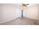 Bedroom featuring a ceiling fan, closet and an open door to another room or closet at 2707 Morningside Dr, Clearwater, FL 33759