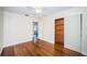 Bedroom showing hardwood floors, with a glimpse into an adjacent room and a closet with cedar wood at 2707 Morningside Dr, Clearwater, FL 33759
