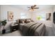 Cozy bedroom showcasing a neutral color scheme, comfortable king-size bed, and views from windows on two walls at 2707 Morningside Dr, Clearwater, FL 33759