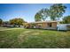 Stylish single-story home with lush green lawn and clean white fence, creating curb appeal at 2707 Morningside Dr, Clearwater, FL 33759