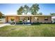 Charming single-story home with covered porch, manicured lawn and beautiful landscaping at 2707 Morningside Dr, Clearwater, FL 33759