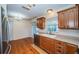 Traditional kitchen featuring wood cabinets, stainless steel appliances, and hardwood flooring at 2707 Morningside Dr, Clearwater, FL 33759