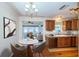 Bright kitchen features wood floors, stainless steel appliances and wood cabinets with a breakfast table at 2707 Morningside Dr, Clearwater, FL 33759