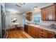 Bright kitchen features wood floors, stainless steel appliances and wood cabinets with a breakfast table at 2707 Morningside Dr, Clearwater, FL 33759