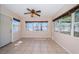 Empty living room featuring tile floors, large windows, and neutral paint at 2707 Morningside Dr, Clearwater, FL 33759