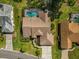 Aerial view of a home with a screened-in pool, manicured lawn, and mature landscaping at 2806 Forest Club Dr, Plant City, FL 33566