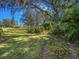 Spacious backyard with mature trees and manicured landscaping at 2806 Forest Club Dr, Plant City, FL 33566