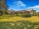 A well-maintained backyard features a screened-in pool and trimmed perimeter hedges at 2806 Forest Club Dr, Plant City, FL 33566