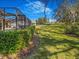 Beautifully landscaped backyard featuring a screened-in pool area at 2806 Forest Club Dr, Plant City, FL 33566