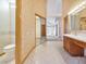 Bright bathroom featuring tile flooring, toilet and a vanity with sink, providing practicality and style at 2806 Forest Club Dr, Plant City, FL 33566