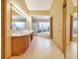Well-lit bathroom featuring double sinks, tile flooring, and separate bathtub and shower, offering luxury and comfort at 2806 Forest Club Dr, Plant City, FL 33566